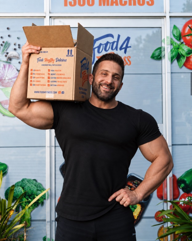 Food4Fitness founder Giancarlo Coratella holding a Food4Fitness delivery box